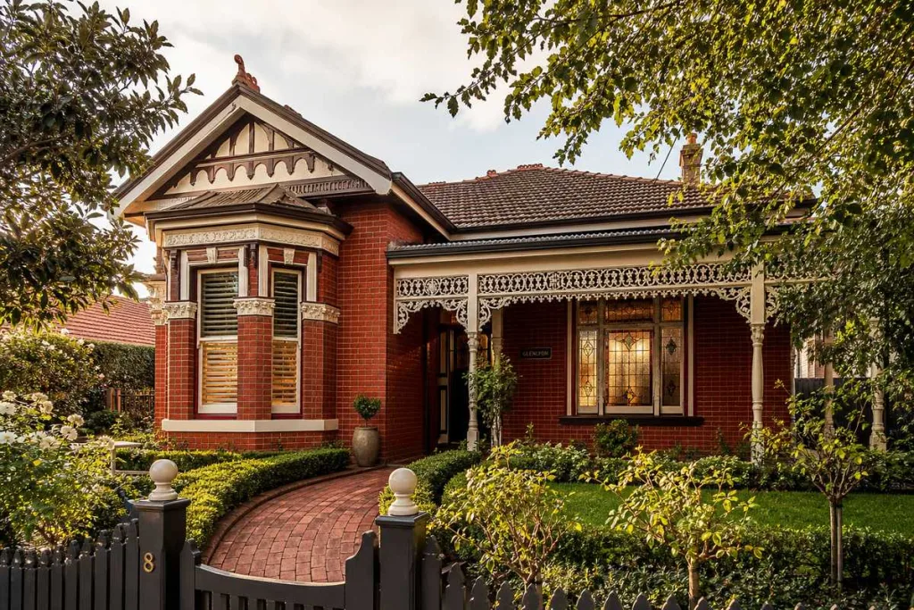 Elegant Edwardian home design Melbourne with red brick facade and timber fretwork verandah