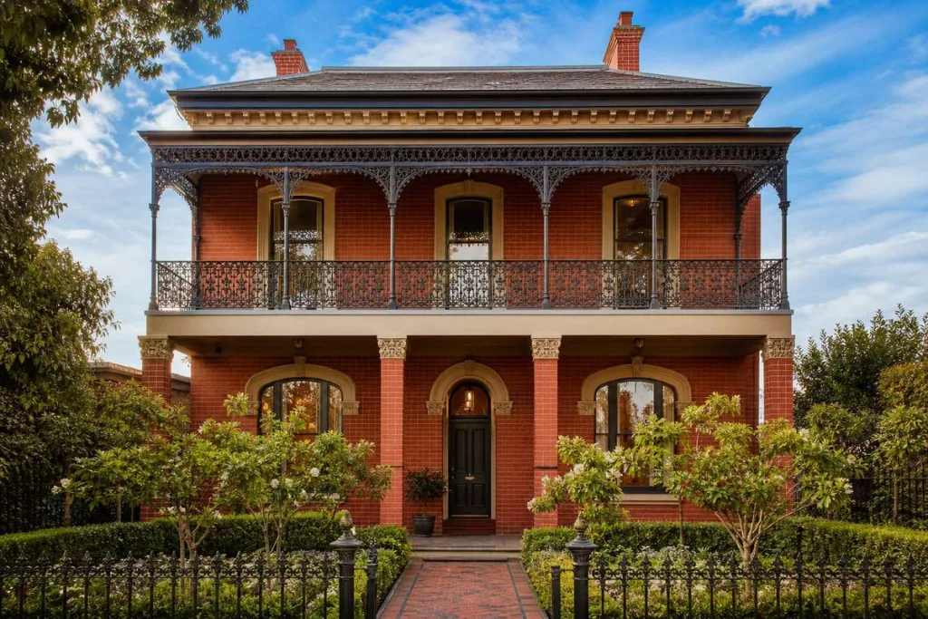 Two-storey heritage-style custom home in Melbourne with balcony and landscaped front garden
