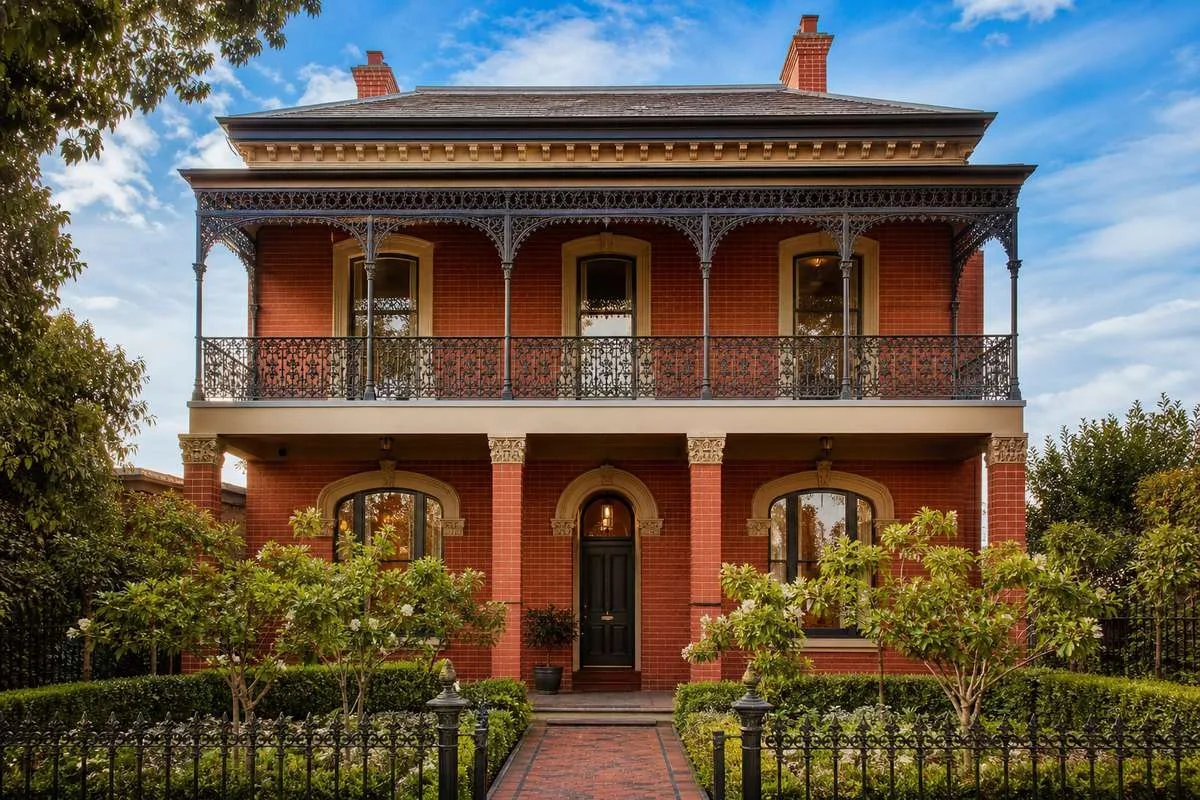 Two-storey heritage-style custom home in Melbourne with balcony and landscaped front garden