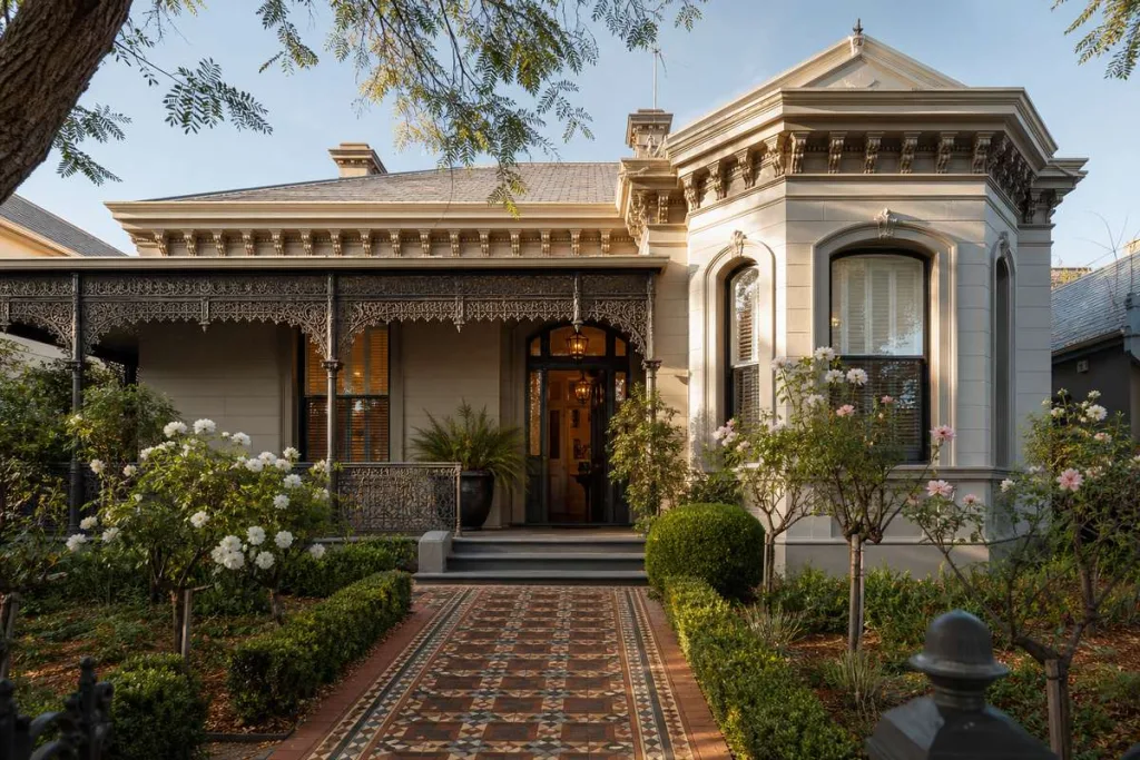 Victorian-era heritage home in Melbourne with ornate lacework verandah and tessellated tile path