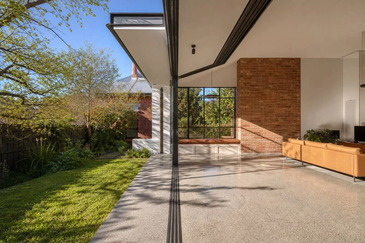 Melbourne custom home with passive solar design features including north-facing eaves, double glazing and thermal mass brick wall