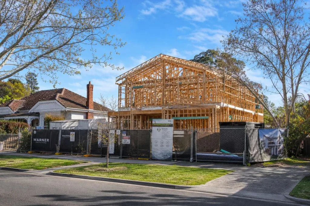 Melbourne custom home construction site in spring with new timber framing in a leafy period suburb
